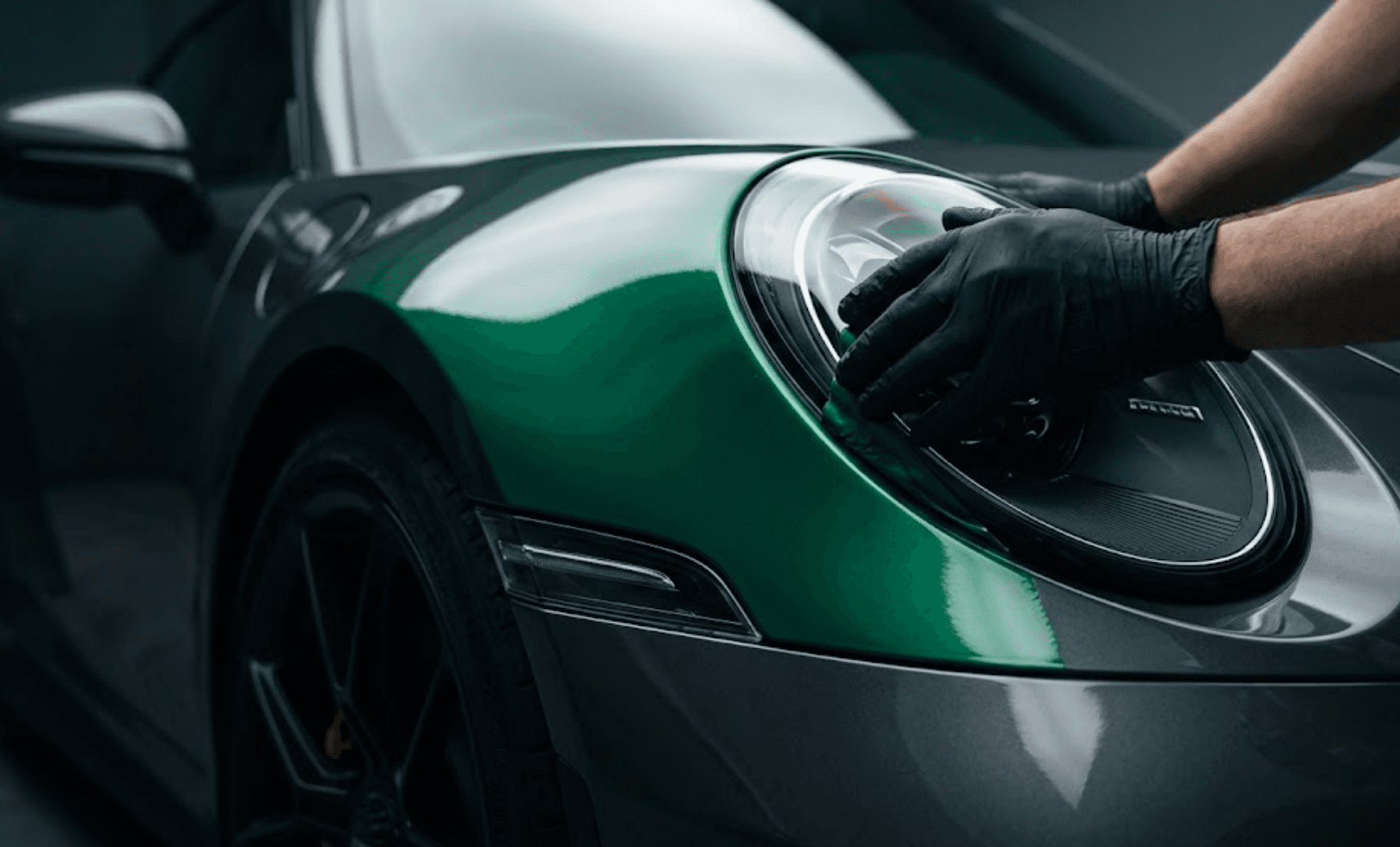 Colored wrap finish on a luxury vehicle — cinematic macro reflection.